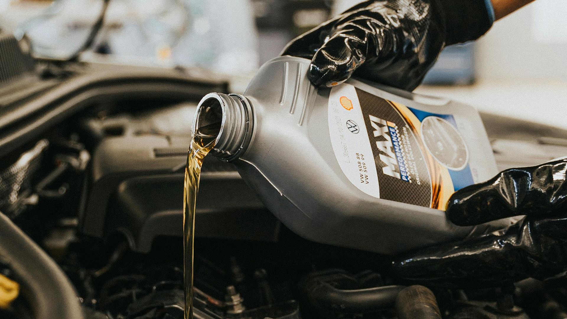 Adding oil to car