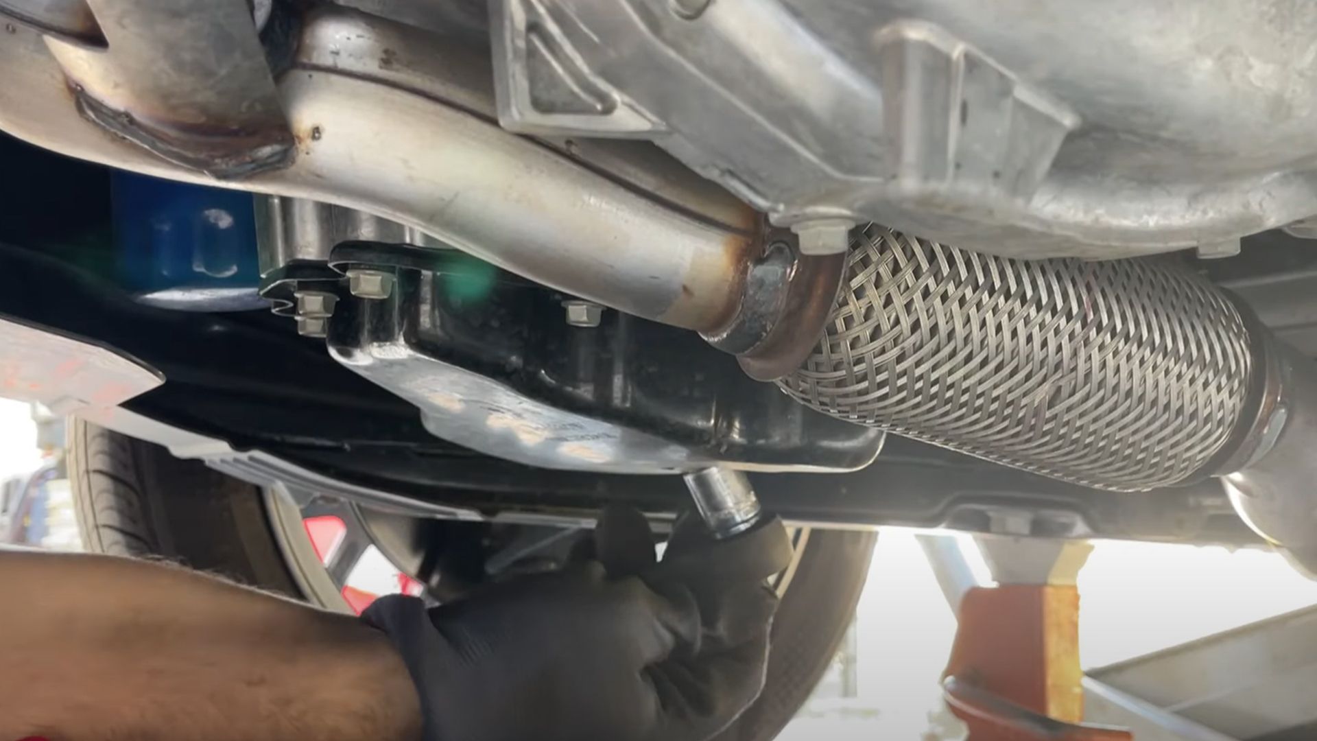 Engine oil being drained under car