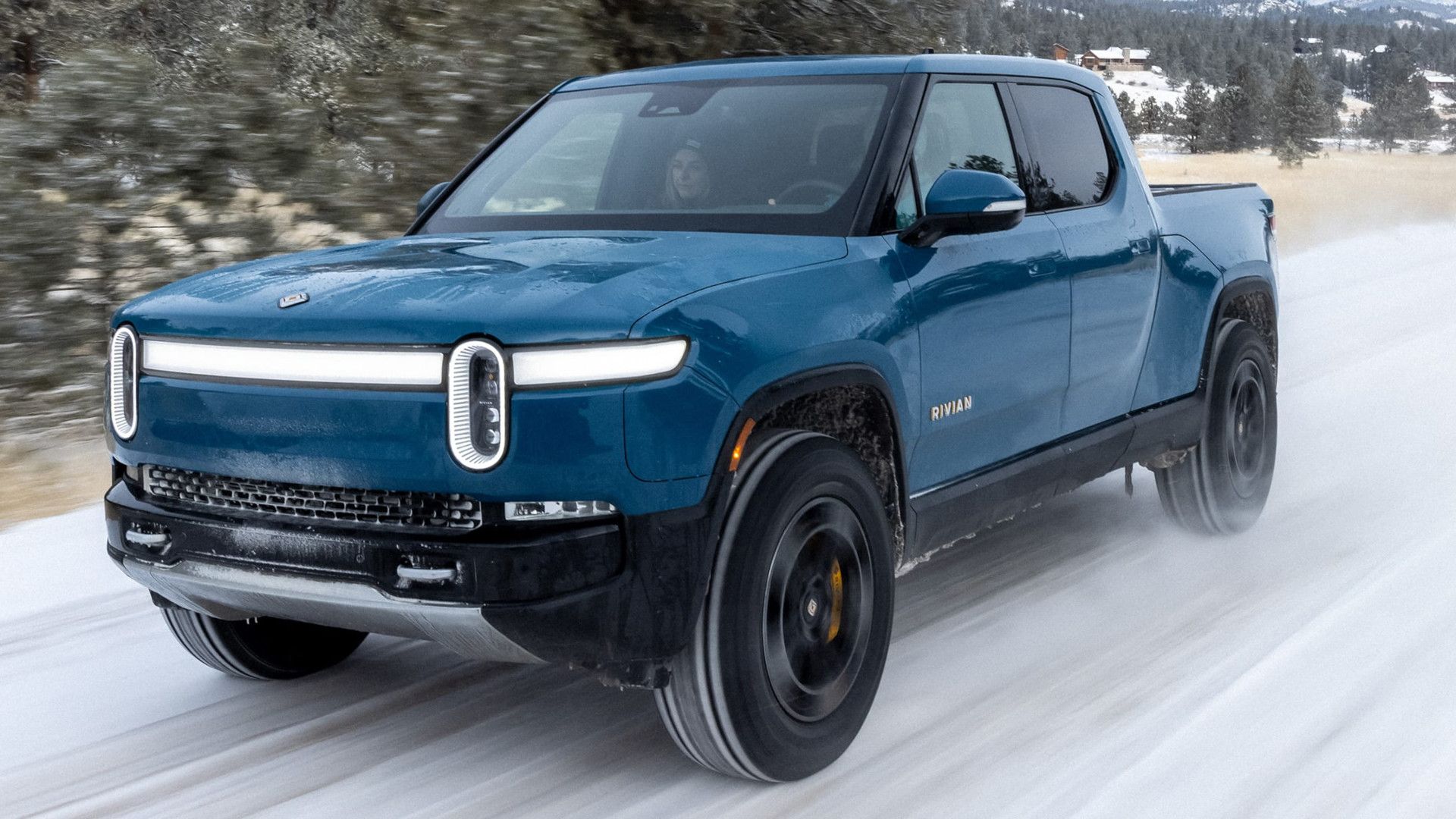 2025 Rivian R1T Blue Front Angle Snow Driving
