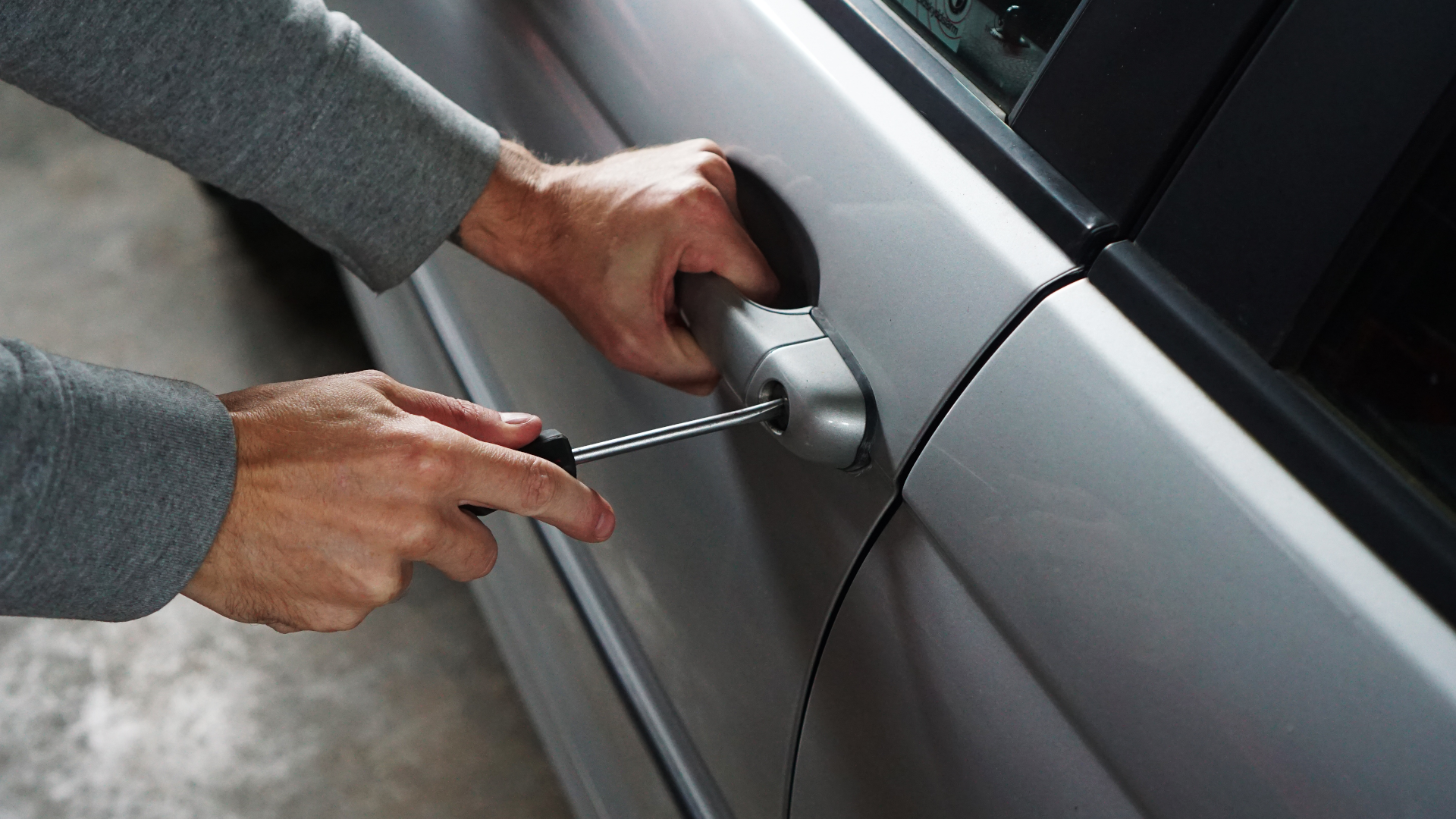 car-thief Car Thief Breaking In With A Screwdriver