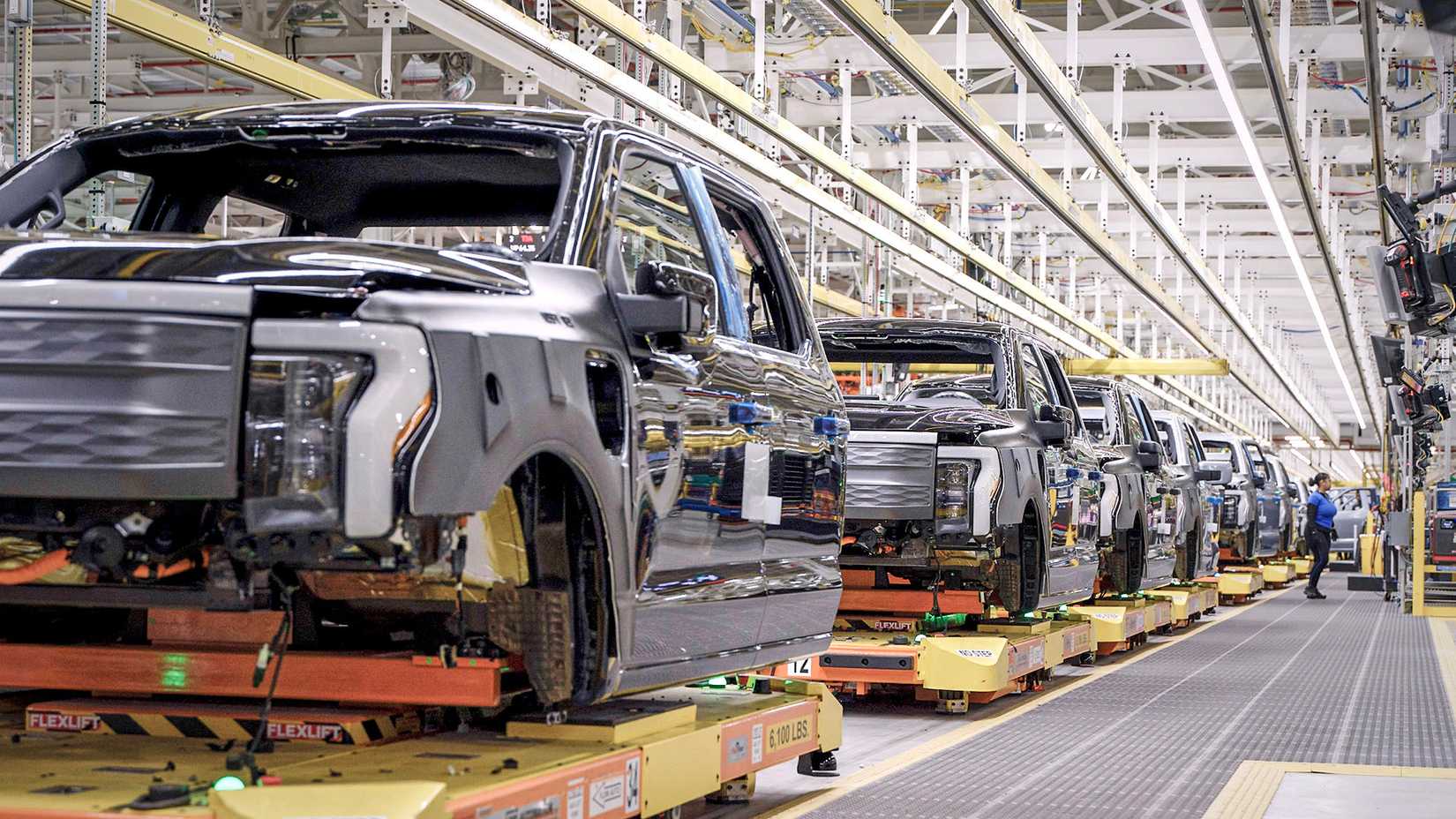 Multiple Ford F-150 Lightning trucks roll down assembly line